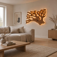 Branching wall sconce shaped like coral with a warm glow behind its edges in a Scandinavian living room with white walls