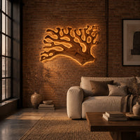Branching wall sconce shaped like coral with a warm glow behind its edges in an industrial loft living room with exposed brick