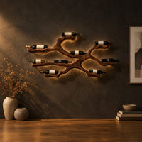 Branching wood wine bottle holder with a cradle at each branch tip in a dark studio against a charcoal plaster wall