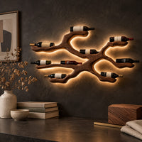 Corner detail of branching wood wine bottle holder with a cradle at each branch tip beside wood, brass and linen samples