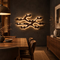 Branching wood wine bottle holder with a cradle at each branch tip in a dark dining room at golden hour