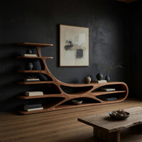 TV stand with branching floating shelves on a carved base in a dark studio against a charcoal wall