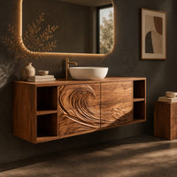 Corner detail of floating vanity with carved breaking wave fronts and open cubbies at both ends beside wood, brass and linen samples