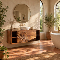 Floating vanity with carved breaking wave fronts and open cubbies at both ends in a bright bathroom with arched windows and plants