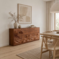 Sideboard with a carved breaking wave across the doors in a Scandinavian dining room with white walls