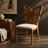 Corner detail of chair with a pierced butterfly wing backrest and padded seat beside wood, brass and linen samples