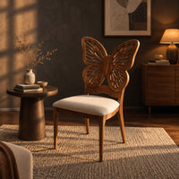 Chair with a pierced butterfly wing backrest and padded seat in a dark living room at golden hour
