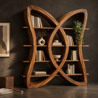 Corner detail of butterfly shaped bookshelf made of two crossing loops with shelves beside wood, brass and linen samples