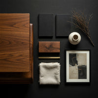 Corner detail of cantilever coffee table with a two drawer box base beside wood, brass and linen samples