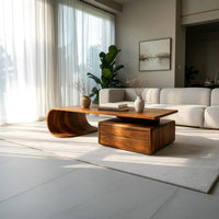 Cantilever coffee table with a two drawer box base in a sunlit room with large windows and plants