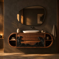 Pill shaped floating bathroom vanity with a black carved wave front in a dark bathroom at golden hour