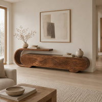 Capsule shaped tv stand with carved wave panels and a scroll end ledge in a Scandinavian living room with white walls