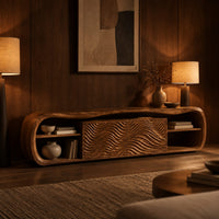 Low capsule shaped wooden tv stand with wave carved panels and open end shelves in an evening living room with walnut wall paneling