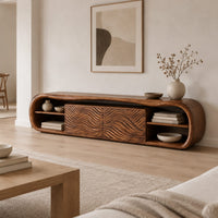 Low capsule shaped wooden tv stand with wave carved panels and open end shelves in a Scandinavian living room with white walls