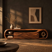 Capsule shaped tv stand with wave carved panels and open end shelves in a dark living room at golden hour