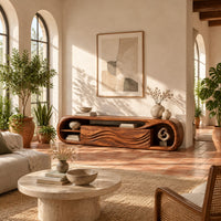 Capsule shaped tv stand with wave carved panels and open end shelves in a bright living room with arched windows and plants