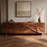 Corner detail of tv stand with a carved branch relief across four front panels beside wood, brass and linen samples