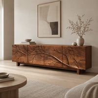 Tv stand with a carved branch relief across four front panels in a Scandinavian living room with white walls