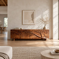 Tv stand with a carved branch relief across four front panels in a bright open plan living room