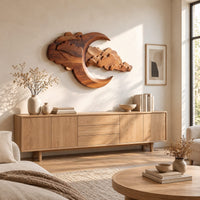 Carved crescent moon wall art with a bank of layered scalloped clouds above a light oak sideboard in daylight