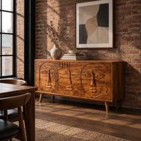 Mid century sideboard with three carved faces and four tapered legs in an industrial loft dining room with exposed brick