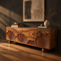 Sideboard with carved fan motifs across four panels and ball feet, three-quarter view showing the grain