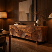 Sideboard with carved fan motifs across four panels and ball feet in an evening dining room with walnut wall paneling
