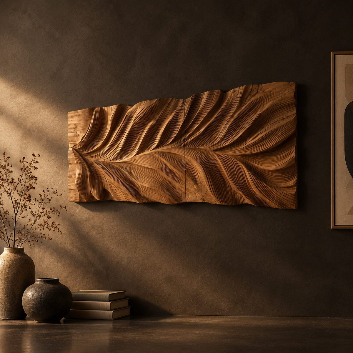 Wide wall art panel carved in a feather shaped leaf with sweeping ridges on a dark charcoal plaster wall