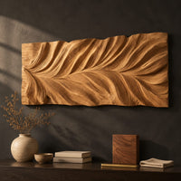 Detail of wide wall art panel carved in a feather shaped leaf with sweeping ridges beside wood, brass and linen samples