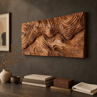 Detail of wide wood relief wall art carved with flowing contour ridges beside wood, brass and linen samples
