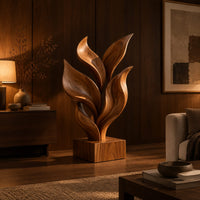 Sculpture of smooth carved leaves rising from a square block base in an evening living room with walnut wall paneling