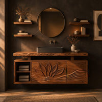 Bathroom vanity cabinet with a carved leaf pattern and a raised live edge top in a dark bathroom at golden hour