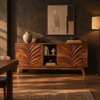 Sideboard with two leaf carved panels and an open center shelf unit in a dark dining room at golden hour