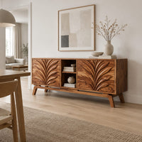 Sideboard with two leaf carved panels and an open center shelf unit in a Scandinavian dining room with white walls