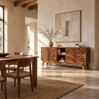 Sideboard with two leaf carved panels and an open center shelf unit in a bright open plan dining room