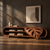 Capsule shaped tv stand with open shelves and a carved leaf panel, three-quarter view showing the grain