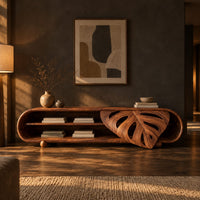 Capsule shaped tv stand with open shelves and a carved leaf panel in a dark living room at golden hour