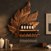 Corner detail of carved leaf wine rack with a bottle ledge and glass hangers beside wood, brass and linen samples