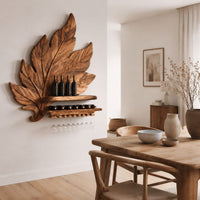 Carved leaf wine rack with a bottle ledge and glass hangers in a Scandinavian dining room with white walls