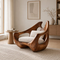 Carved lounge chair with a deep wooden shell and open oval cutouts in a Scandinavian living room with white walls
