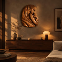 Wall art carved as a mother holding her child, with long flowing hair above a low console in an evening living room