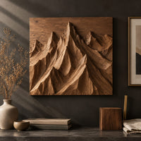 Detail of wood wall art with carved mountain peaks in deep relief beside wood, brass and linen samples