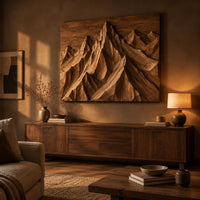 Wood wall art with carved mountain peaks in deep relief above a low console in an evening living room