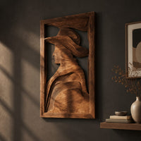 Carved wall art of a profile in a wide brim hat, three-quarter view showing the carved depth