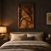 Carved wall art of a profile in a wide brim hat above a bed in a dusk lit bedroom