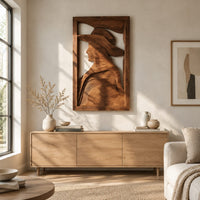 Carved wall art of a profile in a wide brim hat above a light oak sideboard in daylight