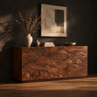 Sideboard with a carved sunrise and rolling waves across three doors, three-quarter view showing the grain
