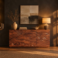 Sideboard with a carved sunrise and rolling waves across three doors in a dark dining room at golden hour