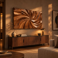 Landscape wood wall art panel with a carved swirl relief above a low console in an evening living room