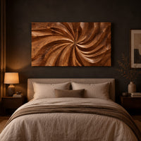 Landscape wood wall art panel with a carved swirl relief above a bed in a dusk lit bedroom